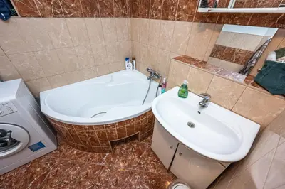 a bathroom with a tub and a sink and a toilet at Apartment Lublanska 48 in Prague