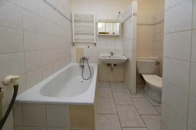 a bathroom with a tub and a sink and a toilet at Apartment Lublanska 48 in Prague