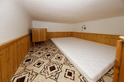a small room with a bed and a rug at Apartment Lublanska 48 in Prague