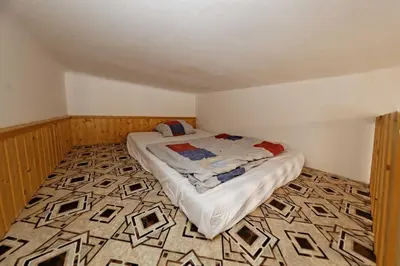 a small bedroom with a bed in the corner of a room at Apartment Lublanska 48 in Prague