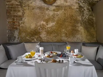 a white table with plates of food on it at Hotel La Romantica in Mladá Boleslav