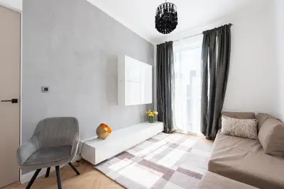a living room with a couch and a chair at Luxury apartment with a balcony and a terrace in Prague