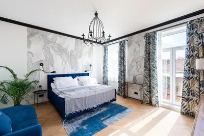 a bedroom with a blue bed and a blue couch at Luxury apartment with a balcony and a terrace in Prague