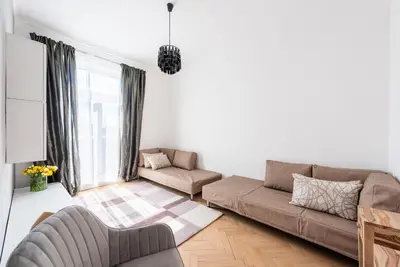 a living room with a couch and a chair at Luxury apartment with a balcony and a terrace in Prague