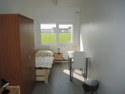 a room with a table and a chair and a window at Sportovní areál Horní Počaply in Horní Počaply