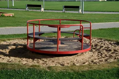 a small red playground in the sand in a park at Sportovní areál Horní Počaply in Horní Počaply