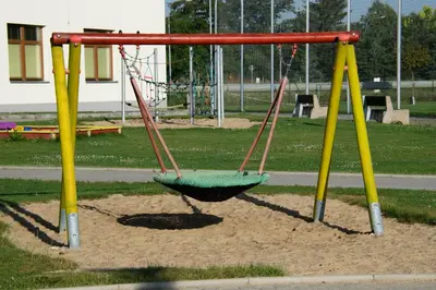 a swing set in a playground in a park at Sportovní areál Horní Počaply in Horní Počaply