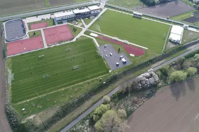 an aerial view of a farm with animals in a field at Sportovní areál Horní Počaply in Horní Počaply