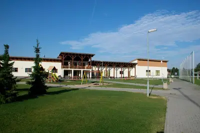a large building with a playground in a park at Sportovní areál Horní Počaply in Horní Počaply