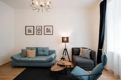 a living room with two chairs and a couch at Apartment Gesse Březinova in Prague
