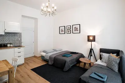 a living room with a bed and a couch at Apartment Gesse Březinova in Prague