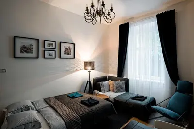 a living room with a couch and a chair at Apartment Gesse Březinova in Prague