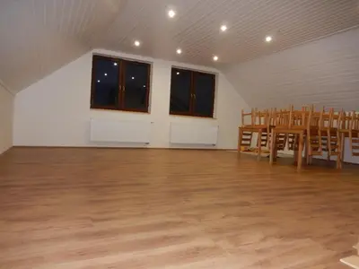 an empty room with chairs and a table and windows at Apartment U Lochů in Kňovičky