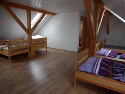 a room with two bunk beds in a attic at Apartment U Lochů in Kňovičky