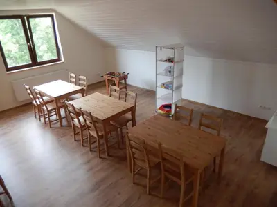 a room with two tables and chairs and a shelf at Apartment U Lochů in Kňovičky