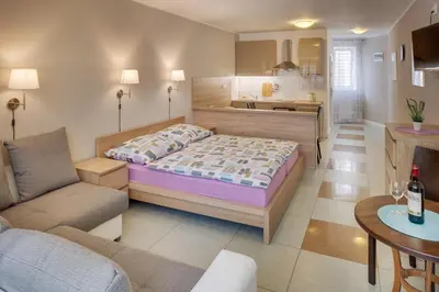 a bedroom with a bed and a living room at Apartements Studio 964 in Líbeznice