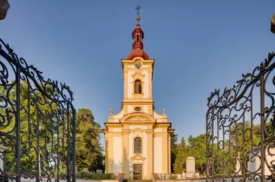 a building with a tower with a clock on it at Apartements Studio 964 in Líbeznice
