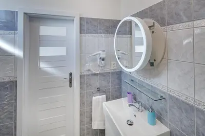 a bathroom with a sink and a mirror at Apartements Studio 964 in Líbeznice