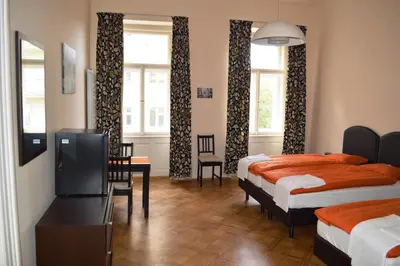 a hotel room with two beds and a television at Valentina Apartments in Prague