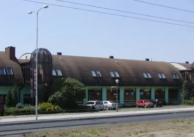 a large building with cars parked in front of it at Hotel BESTAR in Mladá Boleslav