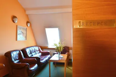 a waiting room with two leather chairs and a table at Hotel BESTAR in Mladá Boleslav