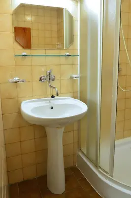 a bathroom with a white sink and a shower at Hotel BESTAR in Mladá Boleslav