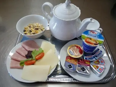 a tray of cheese and other food on a table at Hotel BESTAR in Mladá Boleslav