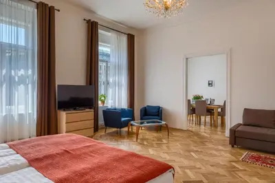 a bedroom with a bed and a living room at Apartments 39 Wenceslas Square in Prague