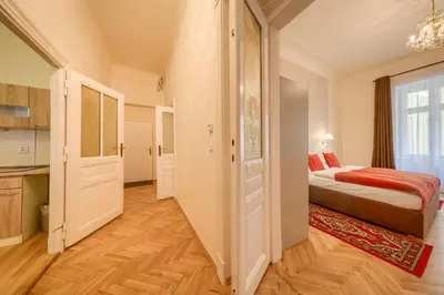 a small bedroom with a bed and a kitchen at Apartments 39 Wenceslas Square in Prague
