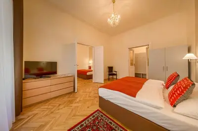 a bedroom with a large bed and a television at Apartments 39 Wenceslas Square in Prague