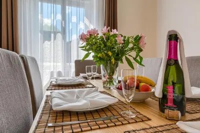 a table with a bottle of wine and flowers on it at Apartments 39 Wenceslas Square in Prague