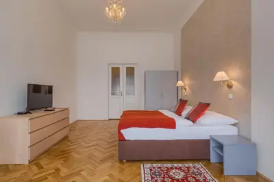 a bedroom with a large bed and a television at Apartments 39 Wenceslas Square in Prague