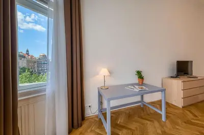 a blue desk in a room with a window at Apartments 39 Wenceslas Square in Prague