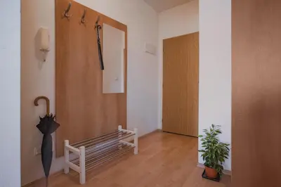 a hallway with a bench and an umbrella at Downtown Apartments Kozatska in Prague