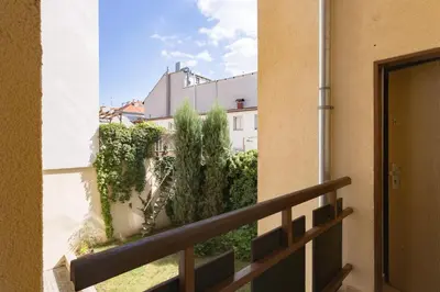 a balcony with a view of a building at Downtown Apartments Kozatska in Prague