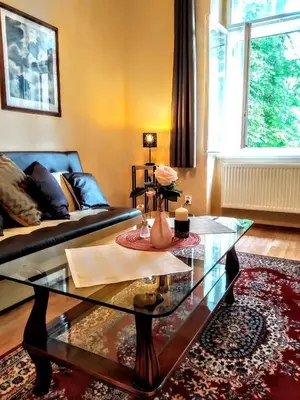 a living room with a couch and a glass table at Apartment Sense of Zizkov in Prague