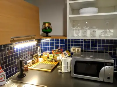 a kitchen with a counter with a microwave in it at Apartment Sense of Zizkov in Prague