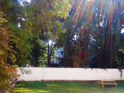 a wooden bench sitting next to a white fence at Apartment Sense of Zizkov in Prague