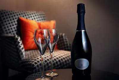 a bottle of wine and two wine glasses on a table at COSMOPOLITAN Hotel Prague in Prague