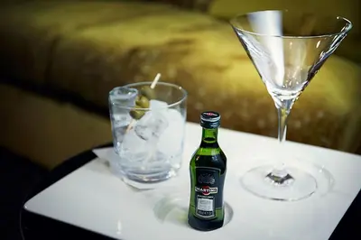 a bottle of beer sitting on a table with a glass at COSMOPOLITAN Hotel Prague in Prague