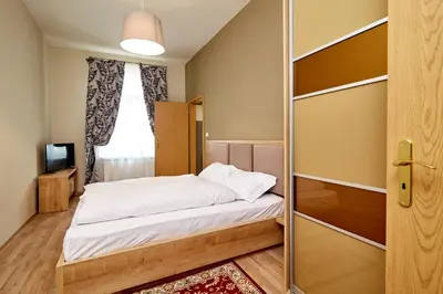 a bedroom with a bed and a sliding glass door at Kasablanka apartments in Prague