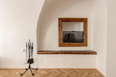a mirror on a wall next to a bench at Studio Nicolas Prague in Prague