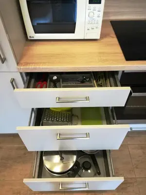 a kitchen drawer with a microwave on top of it at Apartment Promenada in Poděbrady