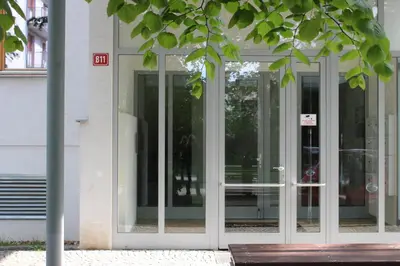 a glass entry door to a building with at Apartment Promenada in Poděbrady