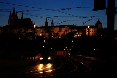 a car driving down a city street at night at Prague Studio Old Town in Prague