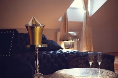 a table with two wine glasses on top of it at Hotel Panství Dlouhá Lhota in Dlouhá Lhota
