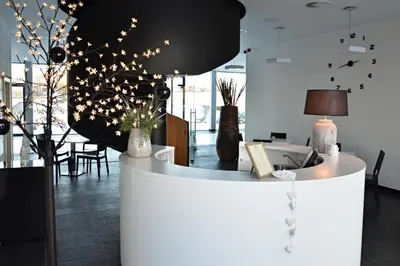 a lobby with a white counter with lights on it at Hotel Panství Dlouhá Lhota in Dlouhá Lhota