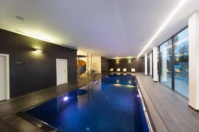 a swimming pool in the middle of a house at Hotel Panství Dlouhá Lhota in Dlouhá Lhota