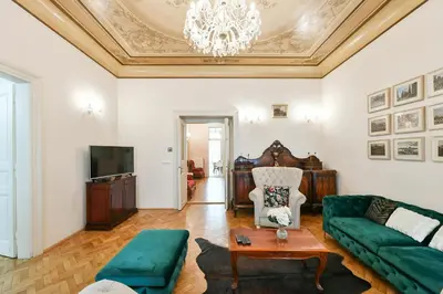 a living room with a couch and a tv at Stunning Charles Bridge Apartment in Prague
