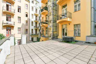 an empty courtyard in front of buildings at Stunning Charles Bridge Apartment in Prague